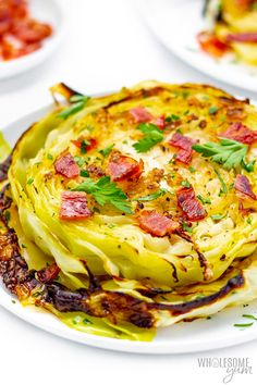 an artichoke dish on a white plate with bacon and parsley garnish