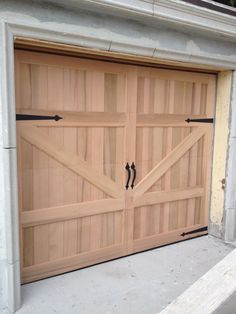 a large wooden garage door on the side of a building