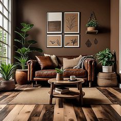 a living room filled with furniture and potted plants on top of wooden flooring