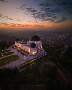 an aerial view of a large building with two domes on top at sunset or dawn