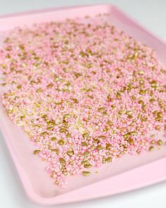 pink and gold sprinkles on a pink tray