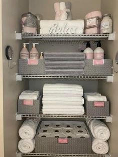 bathroom shelving with towels, soaps and other items in baskets on the shelves