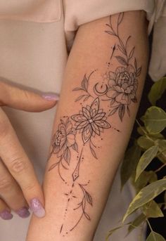 a woman's arm with flowers on it