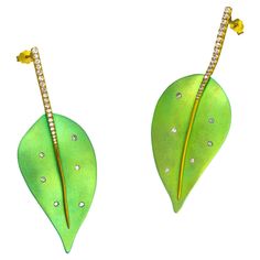 Green Titanium Leaf Earrings 18k Gold with Diamond by Vasilis Giampouras at Second Petale Gallery A pair of titanium leaf earrings captures the vividness of nature. Shaped in organic forms with a bright green color, it makes you feel the freshness and revitalization nature gives. A row of diamonds all along the golden leafstalk enliven the heart of the leaf. The luxury collection is composed of harmony and the distinctness of four different elements. Unique jewels with combinations of gold, titanium, diamonds, gemstones. The malleability and brightness of gold, combined with titanium’s power and color-creating ability, create magic. About the Gemstones: Diamond Round Brilliant Cut: 0.12ct Diamond Single cut:0.44ct ABOUT THE DESIGNER Greek designer Vasilis Giampouras tells us about his jour Titanium Engagement Rings, Contemporary Engagement Rings, Titanium Earrings, International Jewelry, Gold Diamond Earrings, Luxury Collection, Alternative Engagement Rings, Modern Earrings, Feather Earrings