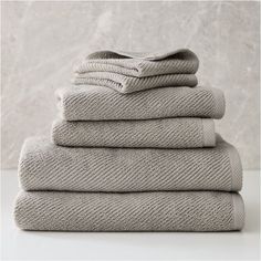 six folded towels stacked on top of each other