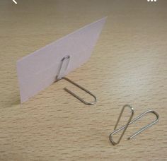 a pair of paper clips sitting on top of a table