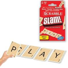 the scrabble slam game is being held up by a person's hand