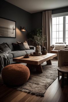 a living room filled with furniture and a wooden table in front of a large window