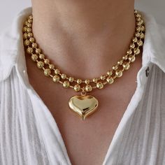 This eye-catching statement necklace has a large puffy heart pendant on a thick gold filled ball chain. The whole piece is made of 18K gold filled brass, which looks almost like 18K solid gold. You can mix and match this necklace with your other gold or gold plated necklaces for a chic look.  This necklace can be sold separately or as a set with another 6 mm plain ball chain. The two chains complement each other and create a layered effect. The set is also available for purchase. MATERIALS: - 18 Bold Necklace Statement Jewelry, Preppy Necklaces, Chunky Gold Chain Necklace, Gold Ball Chain, Preppy Accessories, Chunky Gold Necklaces, Choker Necklace Gold, Chunky Gold Chain, Heart Choker Necklace