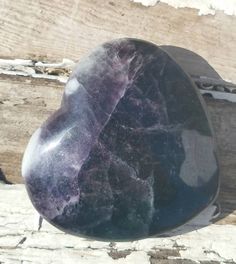 a large purple stone sitting on top of a wooden table