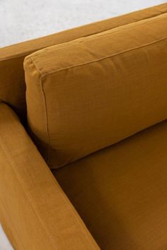 a close up view of the back end of a couch with an arm rest on it