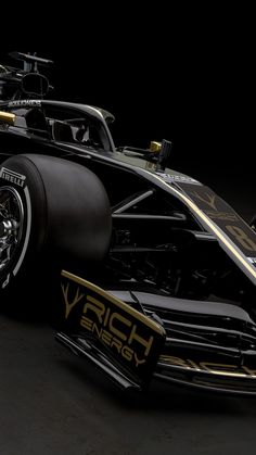 a black and gold race car is shown in this 3d rendering image from the front view