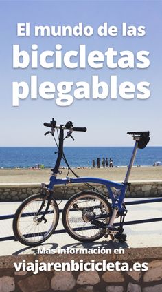 two bicycles parked next to each other in front of the ocean