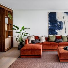 a living room filled with furniture and a painting on the wall