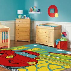 a child's room with blue walls and wooden furniture