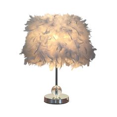 a table lamp with feathers on it