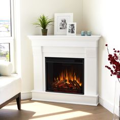 a living room with a fire place and pictures on the wall