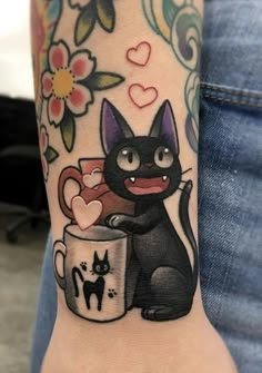 a black cat holding a coffee cup with hearts on it's wrist and the words i love you