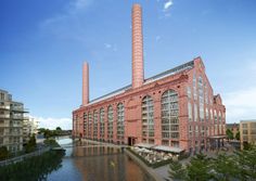 an artist's rendering of a brick factory building next to a body of water