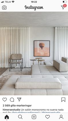 a living room with white furniture and curtains on the window sill, is featured in instagram