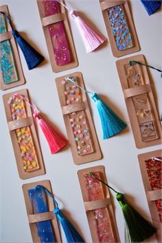 paper bags with tassels and beads on them are lined up in the shape of rectangles