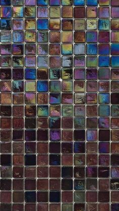 a close up view of a glass mosaic tile wall