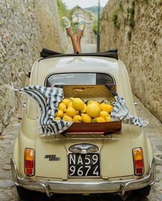 a car with a basket full of lemons in the back