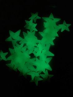 green stars glow in the dark on a black background