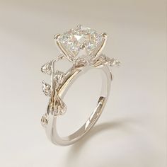 a diamond ring with leaves on the side