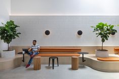 a man sitting on a bench in an office