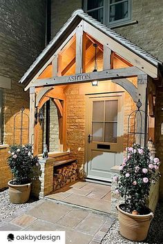 a small wooden building with potted plants outside