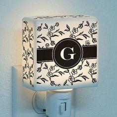 a night light with a monogrammed design on the front and back of it