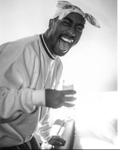 a black and white photo of a man laughing