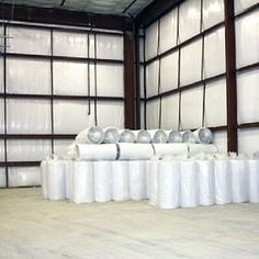 several rolls of toilet paper are lined up in a warehouse