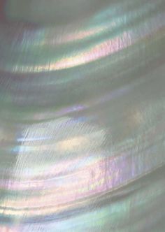 a close up view of an iridescent background with blurry lines on it