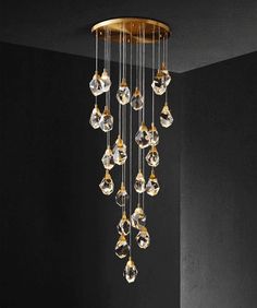 a chandelier with many crystal drops hanging from it's sides in a dark room