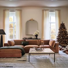 a living room filled with furniture and a christmas tree