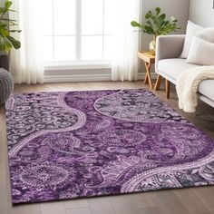 a living room with a purple rug on the floor and a window in the background