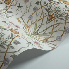 the wall paper is designed with flowers and leaves on it's side, as well as an intricate design