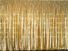 a gold curtain in front of a black wall