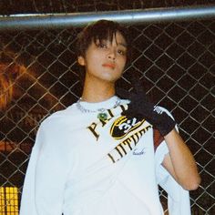 a young man holding a tennis racquet on top of a tennis court