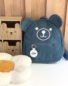 ⚠️Delivery for back to school = orders placed before August 15⚠️ CUSTOM ORDERS & LARGE QUANTITIES possible, contact us 😉 Ideal for preschool years, this pretty teddy bear head bag will become your little one's favorite companion on the way to school. Its size is perfect to accommodate everything you need from small to large sections. Backpack in "sheepskin" faux fur fabric, waterproof lining, one large main zipped pocket, one small zipped pocket at the front, adjustable straps. Round piece in imitation leather personalized with a first name or a word in the font of your choice, text color matching the bag. Bear print made with hot flex. Dimensions: Width 26cm x Height 29cm x Depth 13cm Hand-customized in France. Production of this item within 10-15 days (excluding postal delays). Personal Teddy Backpack, Cheap Cute Bear Design Bags, Teddy Bear Backpack, Bunny Plush Backpack, Elephant Backpack, Bear Head, Faux Fur Fabric, Bear Print, Original Jewelry