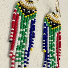 "These \"DAME\" hand-woven earrings have the South African flag on them. You can message us for custom beaded flags by Charmaine Taylor. We create any flags on request. They are super fun statement earrings for anyone who LOVES SOUTH AFRICA. You will have many people looking at and commenting on these beauties. Fantastic for sporting events or international events to literally fly your country's flag. * They are LIGHT weight and have a beautiful flowing movement.  Dame: the title was given to a woman with the rank of Knight Commander. The Dame earring is the 'smaller sister' to the Duchess earrings. Size: 8.5cm in length and 2cm in width MORE: Legacy Collection, as a female-driven company has created a story-telling beaded range to honour the beauty, strength and resilience of women. The b Women Empowerment Project, South Africa Flag, South African Flag, Flag Beads, Women Encouragement, South African, Sport Event, South Africa, Women Empowerment