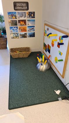 there is a toy airplane on the floor next to a bulletin board