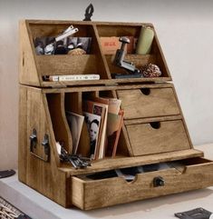 an open wooden box with drawers on top