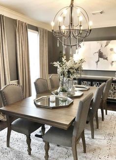 a dining room table with chairs and a chandelier