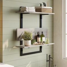 a bathroom with two shelves holding towels, soaps and other personal care items on it