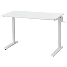 a white computer desk sitting on top of a table