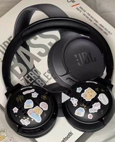 jbl headphones with stickers on them sitting on top of a package for sale