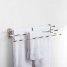 two white towels hanging on a towel rack